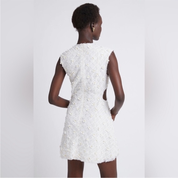 Stunning ivory white open cutting out with delicate flowers cute detailing. - Picture 11 of 16